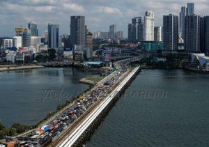 Commuters take the woodlands causeway to singapore from johor a day before malaysia imposes a lockdown on travel due to the coronavirus outbreak