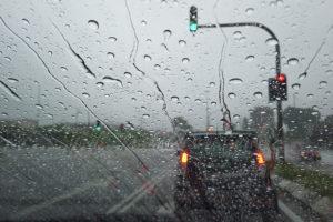 Rain Drop Falling On Car Windshield, Drive Car On Street In City