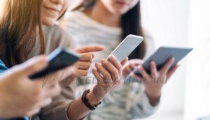 Group Of People Using And Looking At Mobile Phone And Tablet Pc